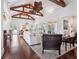 Bright, open living room with hardwood floors, vaulted ceilings, and large windows offering picturesque outdoor views at 7333 Point Of Rocks Rd, Sarasota, FL 34242