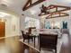 Open-concept living room with hardwood floors, vaulted ceilings with beams, and contemporary furnishings at 7333 Point Of Rocks Rd, Sarasota, FL 34242