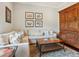 Comfortable living room with a sectional couch, decor, and a wooden cabinet on a patterned rug at 7333 Point Of Rocks Rd, Sarasota, FL 34242