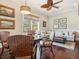 Bright living room with hardwood floors, ceiling fan, and an adjacent sitting area at 7333 Point Of Rocks Rd, Sarasota, FL 34242