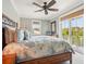 Bright main bedroom with floral bedding and access to private balcony at 7333 Point Of Rocks Rd, Sarasota, FL 34242