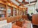 Office featuring custom wood built-ins, coffered ceilings, a ceiling fan, and a view to the exterior at 7333 Point Of Rocks Rd, Sarasota, FL 34242