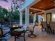 A covered patio features stone floors, a fire pit, and outdoor furniture at 7333 Point Of Rocks Rd, Sarasota, FL 34242