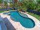 Aerial view of the private pool, spa, waterfall feature, and mature landscaping at 7333 Point Of Rocks Rd, Sarasota, FL 34242