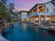 A large backyard pool and spa feature multiple waterfalls and ample seating at 7333 Point Of Rocks Rd, Sarasota, FL 34242