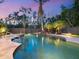 A beautiful backyard pool with a waterfall feature and professional landscaping at 7333 Point Of Rocks Rd, Sarasota, FL 34242