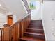 Beautiful staircase with wood treads and railing illuminated by a window at 7333 Point Of Rocks Rd, Sarasota, FL 34242
