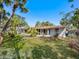View of the rear exterior of home showcasing the siding, roof, and landscaping at 734 Canal Rd, Sarasota, FL 34242