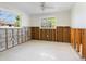 Sunlit bedroom showcases windows with backyard views and wall studs ready for renovation at 734 Canal Rd, Sarasota, FL 34242