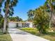 Charming home with manicured lawn, freshly painted exterior, long driveway, and lush landscaping at 734 Canal Rd, Sarasota, FL 34242