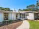 A inviting entrance featuring a quaint walkway, screened doorway, and light blue window accents at 734 Canal Rd, Sarasota, FL 34242
