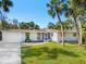 Charming single-story home with palm trees, a brick facade, and a well-manicured lawn at 734 Canal Rd, Sarasota, FL 34242