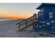 Sunset view of a lifeguard stand on a sandy beach, ideal for safety and scenic walks at 734 Canal Rd, Sarasota, FL 34242