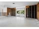 Large living room shows sliding glass doors, exposed wall studs and an open floor plan ready for upgrades at 734 Canal Rd, Sarasota, FL 34242