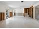 Open-concept living room with ceiling fan, view to the backyard and exposed wall studs offering renovation potential at 734 Canal Rd, Sarasota, FL 34242