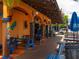 Inviting outdoor restaurant seating with colorful picnic tables and festive lighting at 734 Canal Rd, Sarasota, FL 34242
