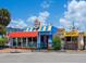 Quaint restaurant with bright blue and yellow exterior, and outdoor seating available at 734 Canal Rd, Sarasota, FL 34242