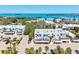 Bright aerial view of a condo complex showcasing the beautiful blue waterfront views in the distance at 750 Bayport Way # 750, Longboat Key, FL 34228