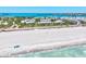 Scenic aerial shot showcases the pristine beach with white sand, turquoise water and the condos in the distance at 750 Bayport Way # 750, Longboat Key, FL 34228