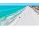 Breathtaking aerial view of the white sandy beach and turquoise ocean water on a sunny day at 750 Bayport Way # 750, Longboat Key, FL 34228