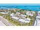Aerial view features beautiful condos, lush landscaping, tropical foliage and close proximity to the water at 750 Bayport Way # 750, Longboat Key, FL 34228