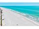Scenic aerial shot showcases the white sand, turquoise water, and sunny blue skies of this pristine beach at 750 Bayport Way # 750, Longboat Key, FL 34228