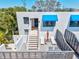 A private outdoor balcony features modern outdoor furniture and a peek of the entrance below at 750 Bayport Way # 750, Longboat Key, FL 34228