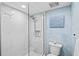 Modern bathroom featuring a glass shower door, marble tile, and stylish fixtures at 750 Bayport Way # 750, Longboat Key, FL 34228