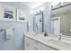 Bright bathroom with double sinks, marble countertops, and modern lighting at 750 Bayport Way # 750, Longboat Key, FL 34228