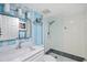 Elegant bathroom with blue accents, modern lighting, and a glass-enclosed shower at 750 Bayport Way # 750, Longboat Key, FL 34228
