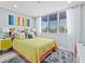 Bright bedroom with large windows, yellow bedding, and modern furnishings for a cozy feel at 750 Bayport Way # 750, Longboat Key, FL 34228