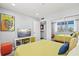 Inviting bedroom with a TV, mirrored closet, and beach-themed decor at 750 Bayport Way # 750, Longboat Key, FL 34228