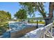 A clean and well-kept bocce ball court framed by shade trees, benches, and plants at 750 Bayport Way # 750, Longboat Key, FL 34228