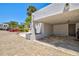 View of the carport with brick-paved driveway and tropical landscaping at 750 Bayport Way # 750, Longboat Key, FL 34228