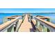 A picturesque view of the community pier showing ample seating areas and gorgeous water views at 750 Bayport Way # 750, Longboat Key, FL 34228