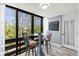 Bright dining area with a glass table and seating for two, offering natural views at 750 Bayport Way # 750, Longboat Key, FL 34228