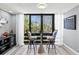 Bright dining area with a view of the outdoor landscape, featuring unique chairs and decor at 750 Bayport Way # 750, Longboat Key, FL 34228