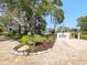 Inviting entrance to the community features lush landscaping and signage for the Bay Port Beach & Tennis Club at 750 Bayport Way # 750, Longboat Key, FL 34228