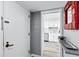 A bright entryway with a view of the kitchen featuring white cabinetry and modern appliances at 750 Bayport Way # 750, Longboat Key, FL 34228