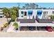 Well maintained condo exterior, showcasing private balcony areas, parking, and lush tropical landscaping at 750 Bayport Way # 750, Longboat Key, FL 34228