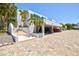 Exterior shot showing a modern condo featuring a carport and covered outdoor staircase entrance at 750 Bayport Way # 750, Longboat Key, FL 34228