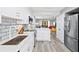 Well-appointed kitchen with white cabinetry, stainless steel appliances, and an open concept design at 750 Bayport Way # 750, Longboat Key, FL 34228