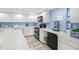 Functional kitchen with ample counter space, white cabinetry, and modern appliances at 750 Bayport Way # 750, Longboat Key, FL 34228