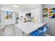 Modern kitchen with white cabinets, stainless steel appliances, and a breakfast bar with seating at 750 Bayport Way # 750, Longboat Key, FL 34228