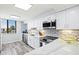 Stylish kitchen featuring white cabinetry, stainless steel appliances, and a bright, airy atmosphere at 750 Bayport Way # 750, Longboat Key, FL 34228