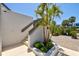 Professionally landscaped condo exterior featuring a brick-paved driveway and manicured tropical landscaping at 750 Bayport Way # 750, Longboat Key, FL 34228