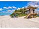 Beachside lifeguard station with a green utility vehicle parked nearby at 750 Bayport Way # 750, Longboat Key, FL 34228