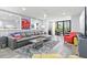Spacious living room with stylish sofa, mirrors, and access to the outside at 750 Bayport Way # 750, Longboat Key, FL 34228
