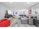 Bright, open living space featuring a modern sofa, vibrant artwork, and sleek entertainment center at 750 Bayport Way # 750, Longboat Key, FL 34228
