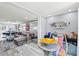 Bright living room with a gray sectional, modern decor, and open concept dining area at 750 Bayport Way # 750, Longboat Key, FL 34228